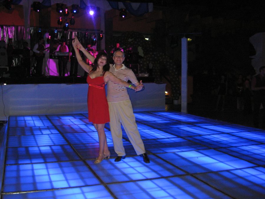 Tibor and Megan dancing Latin on a colourful floor